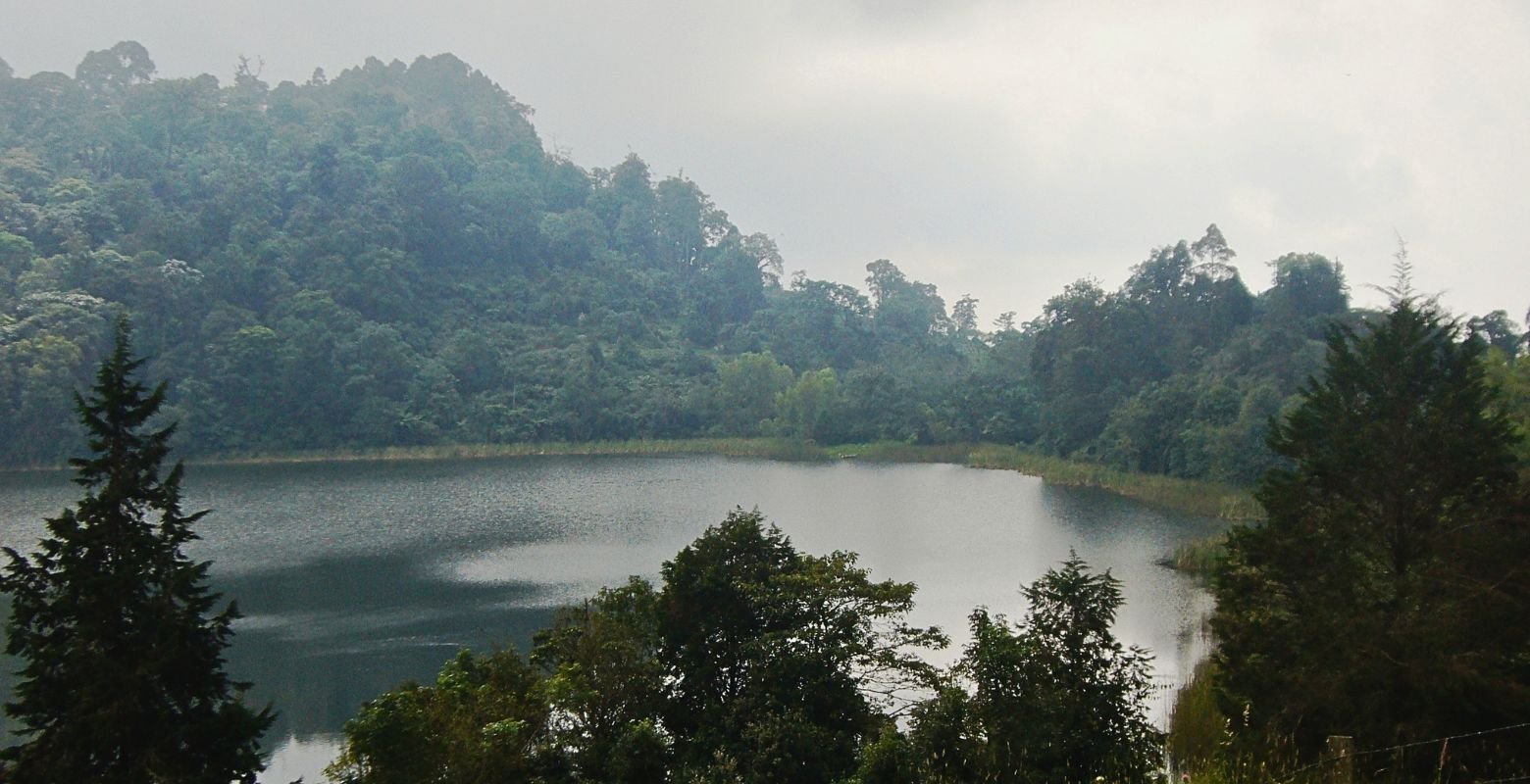 Panoramic view of Pedro Palo Lagoon surrounded by Andean forest and mountains in Cundinamarca, Colombia